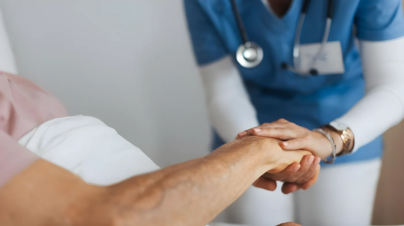 A close-up image of a care worker holding a patient