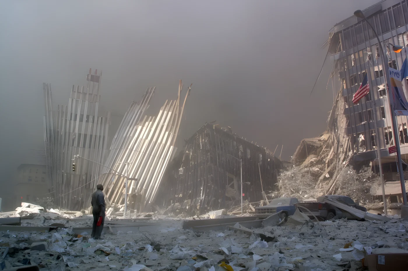 A man stands in the rubble, calling out asking if anyone needs help, after the collapse of the first World Trade Center Tower.
