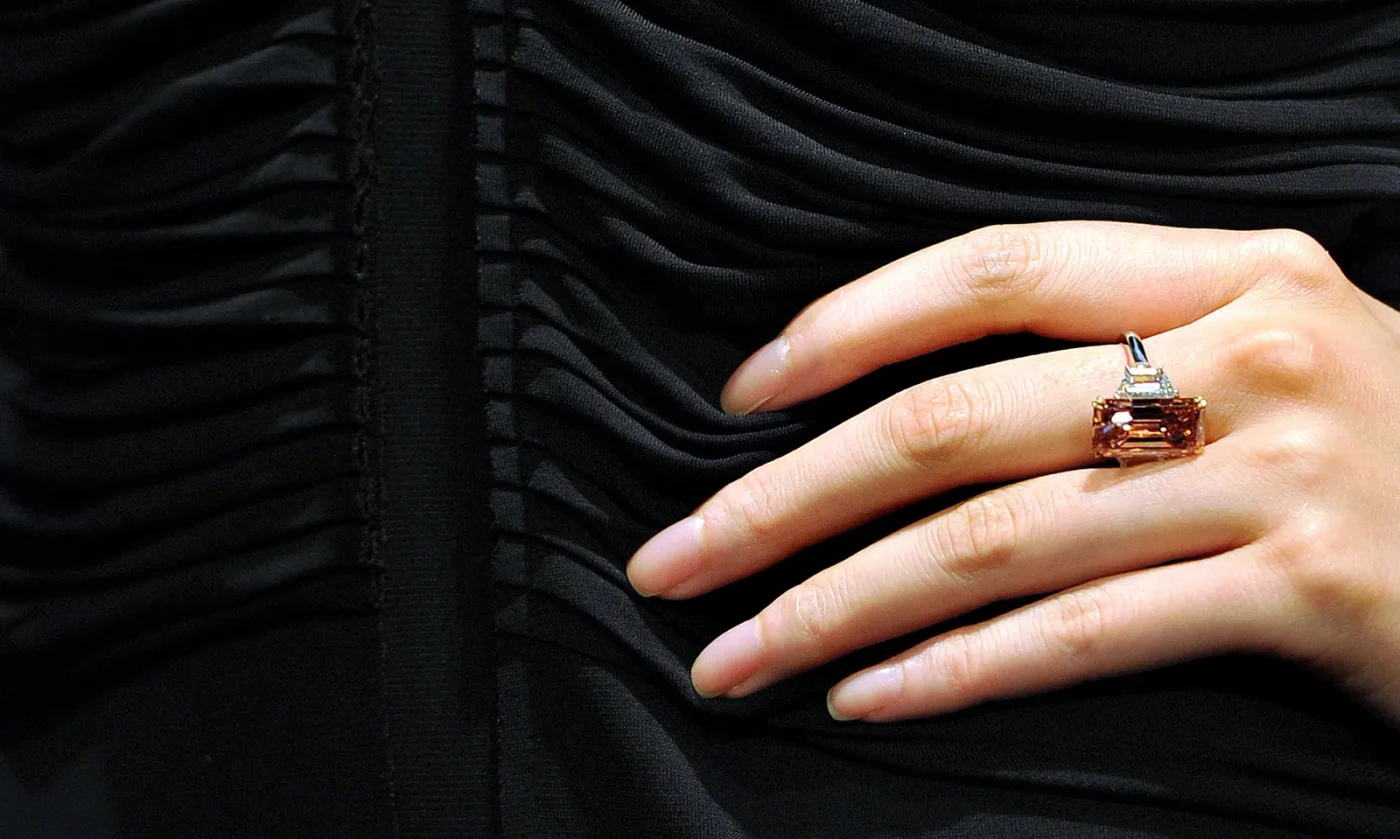 A model presents a 9.27 carat pink and white diamond ring during a press preview at Sotheby