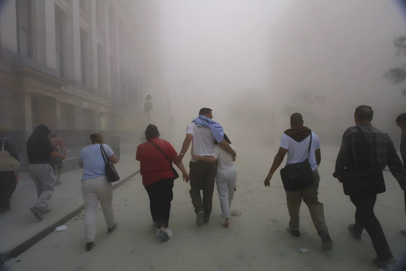 Civilians flee as a tower of the World Trade Center collapses on September 11, 2001, after two airplanes slammed into the twin towers in a terrorist attack.
