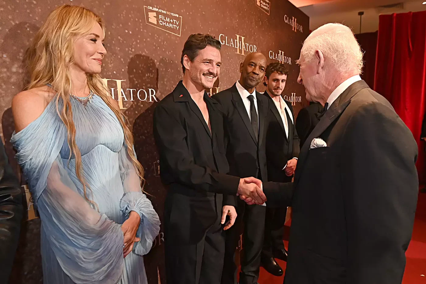 Connie Nielsen looks on as King Charles III meets Pedro Pascal as they attend the Royal Film Performance and Global Premiere of