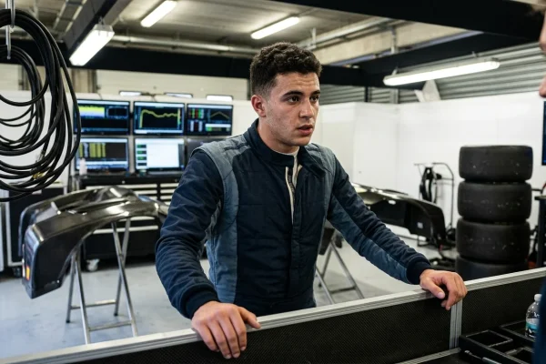 Il pilota Isack Hadjar con la tuta da corsa nei paddock del motorsport