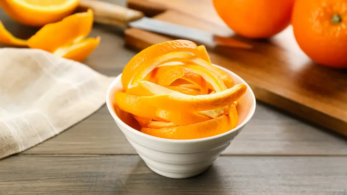 Fresh orange fruit peels on wooden table