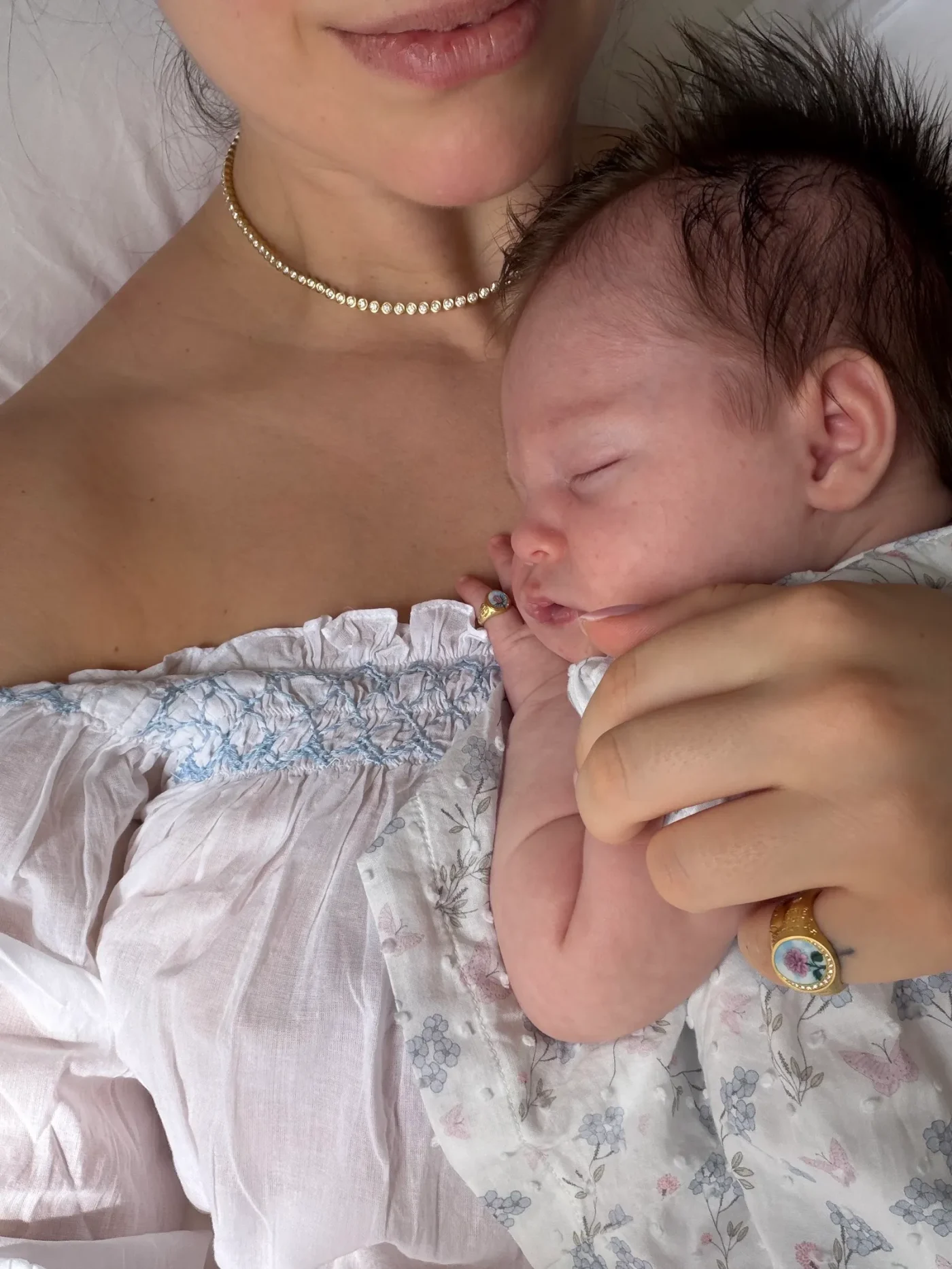 Image may contain Accessories Jewelry Necklace Baby Newborn Person Face Head Photography Portrait and Ring