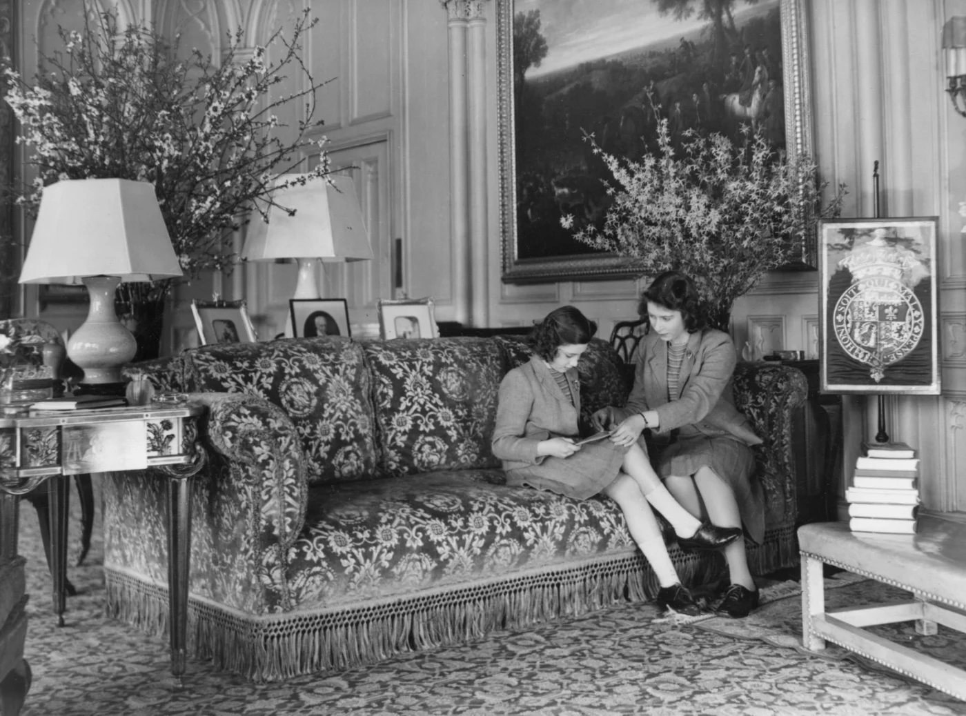 Image may contain Furniture Couch Human Person Living Room Room Indoors Lamp Footwear Clothing Shoe and Apparel