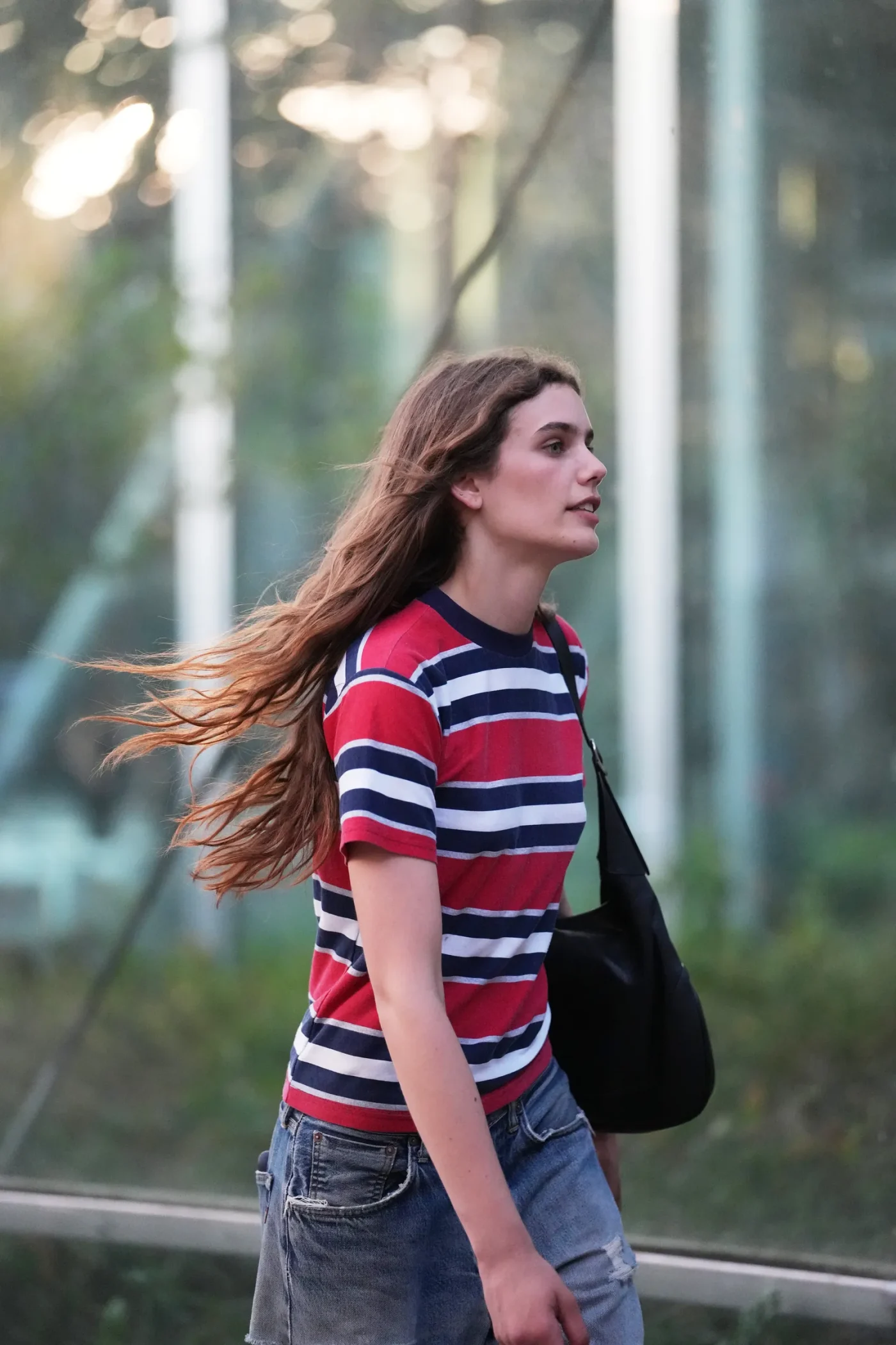 PARIS FRANCE JUNE 24 A guest wears long straight brown hair a red white black striped tshirt wideleg ripped blue...
