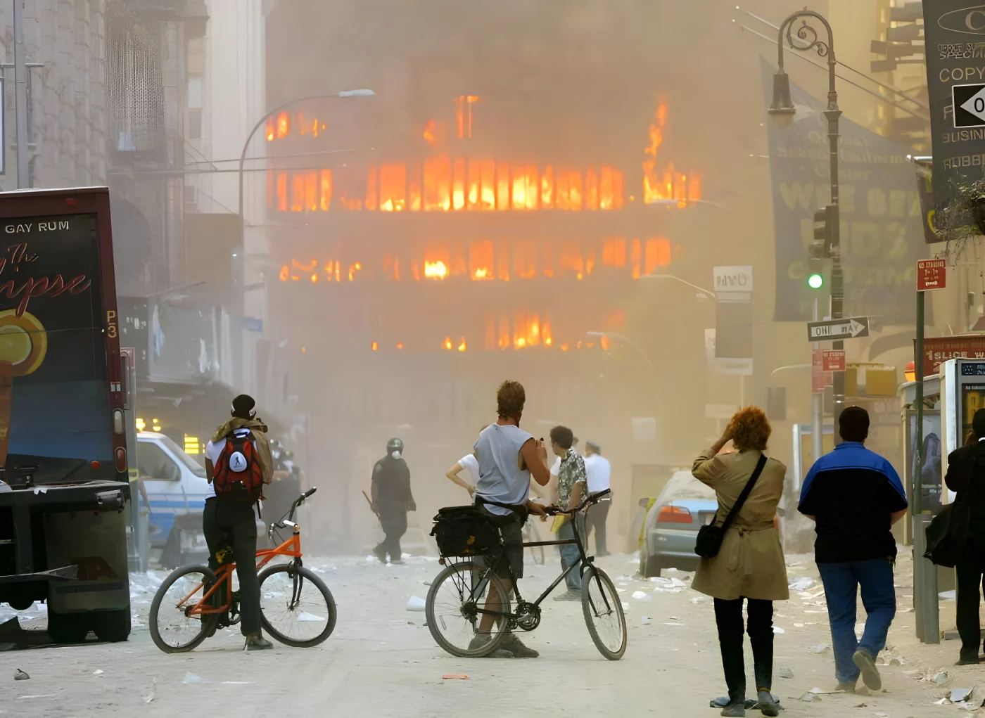 People walk in the street in the area where the World Trade Center buildings collapsed.