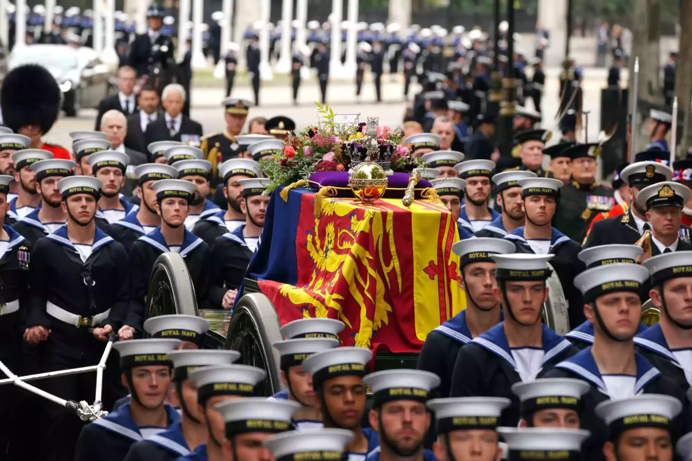 The State Gun Carriage carries the coffin of Queen Elizabeth II, draped in the Royal Standard with the Imperial State Crown and the Sovereign