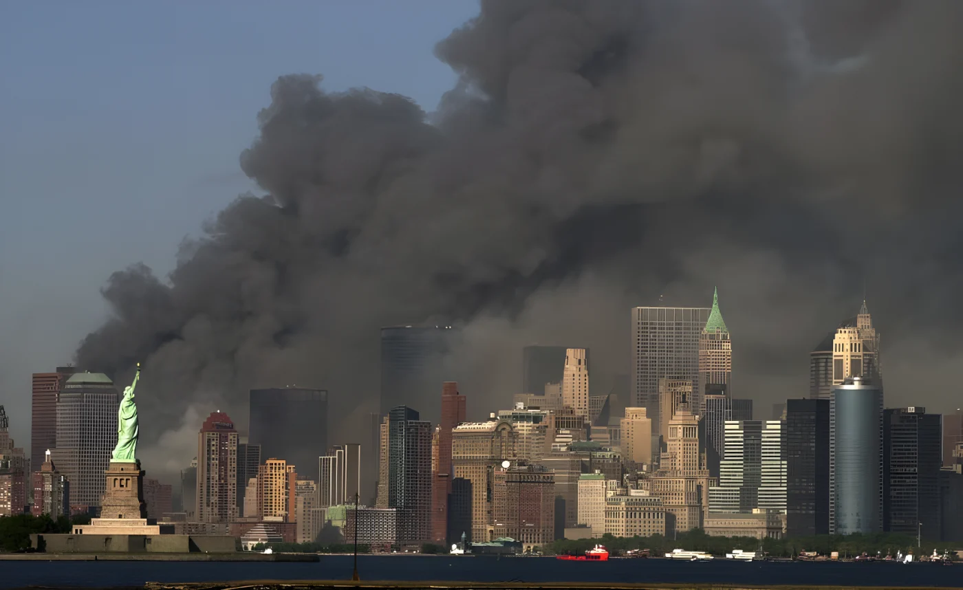 Thick smoke rises into the sky from the area behind the Statue of Liberty, lower left, where the World Trade Center towers stood.
