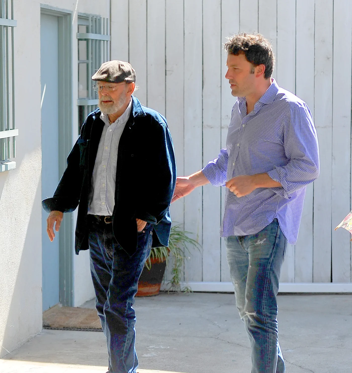 Timothy Affleck and Ben Affleck, walking outdoors.