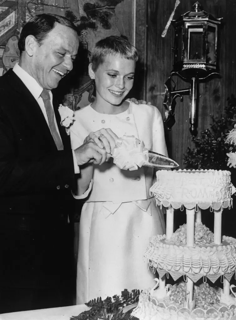 19th July 1966: Singer Frank Sinatra and actress Mia Farrow cutting their wedding cake at Las Vegas