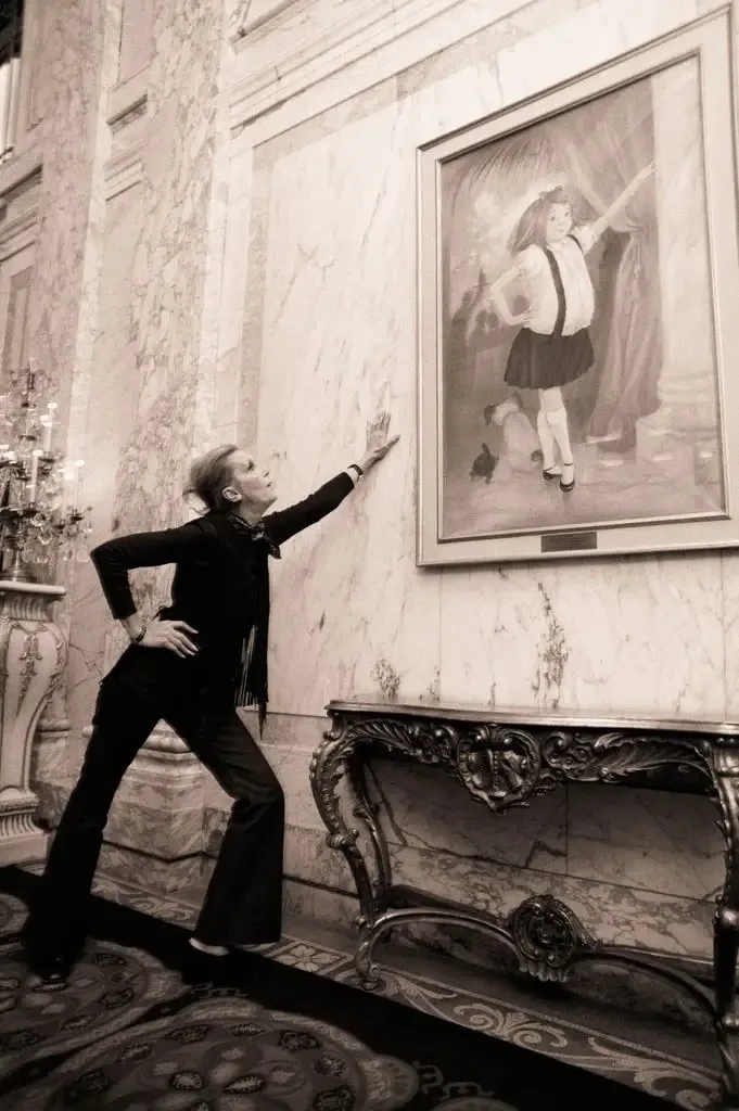 5/5/1969-New York, NY- Long-legged, pant-suited and very sleek, Kay Thompson mimics her brainchild "Eloise," whose portrait is back again in the lobby of New York's swanky Plaza Hotel.Miss Thompson, the sometime entertainer, writer, composer and fashion consultant, created Eloise a while ago and the little moppet won the hearts of young and old alike.She was so popular, the book which told her story was out of print.Now Simon and Schuster has published a new edition and "Eloise" is aroiund for the asking.So is Kay Thompson, in New York- with a wardrobe of her famed pant suits which she started wearting before almost anybody- in honor of Eloise's re-appearance.
