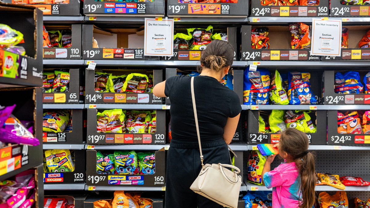 A family shops for Halloween candy at a Walmart Supercenter on October 16, 2024 in Austin, Texas.