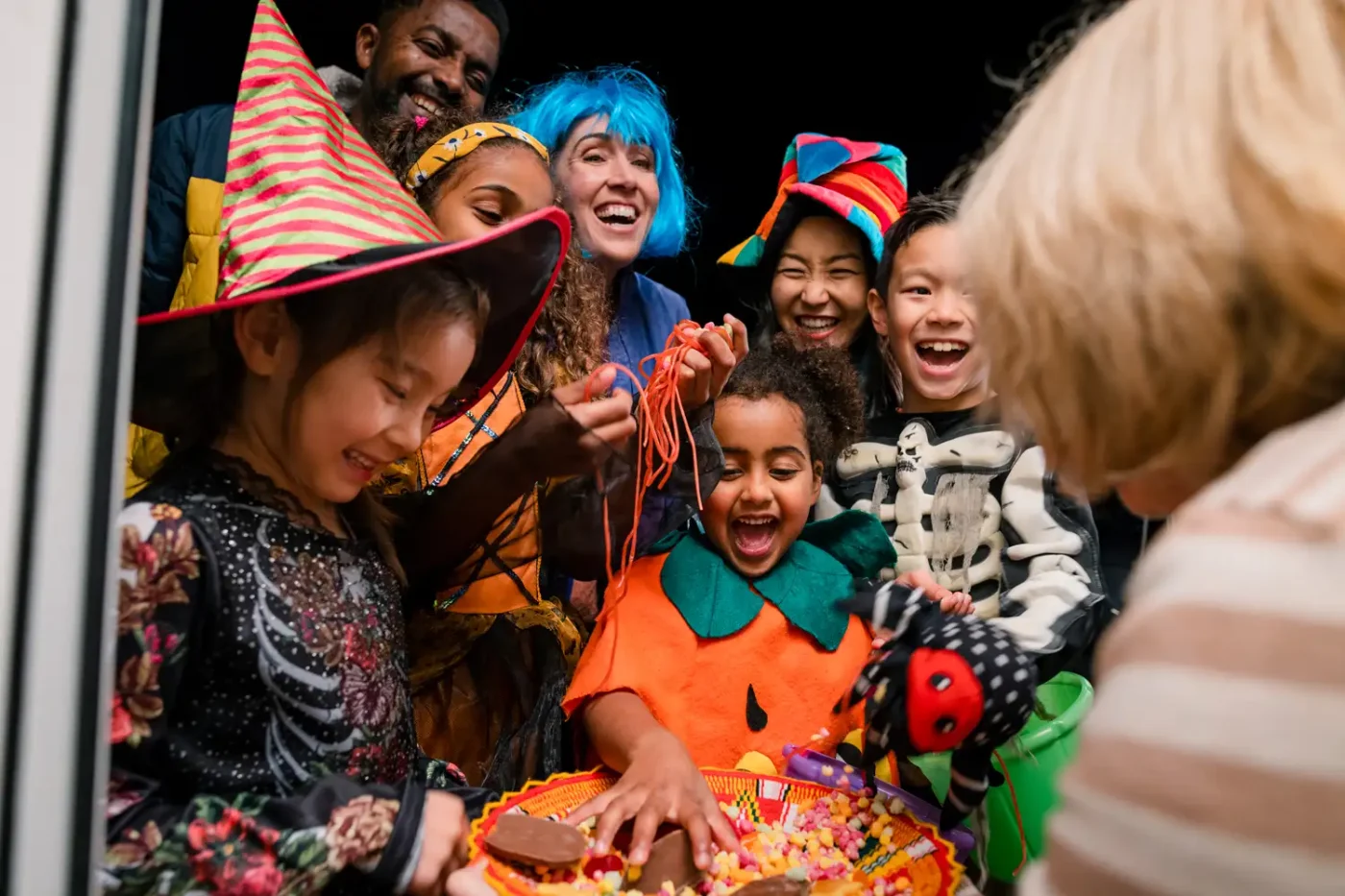 A group of kids collect candy while trick or treating.