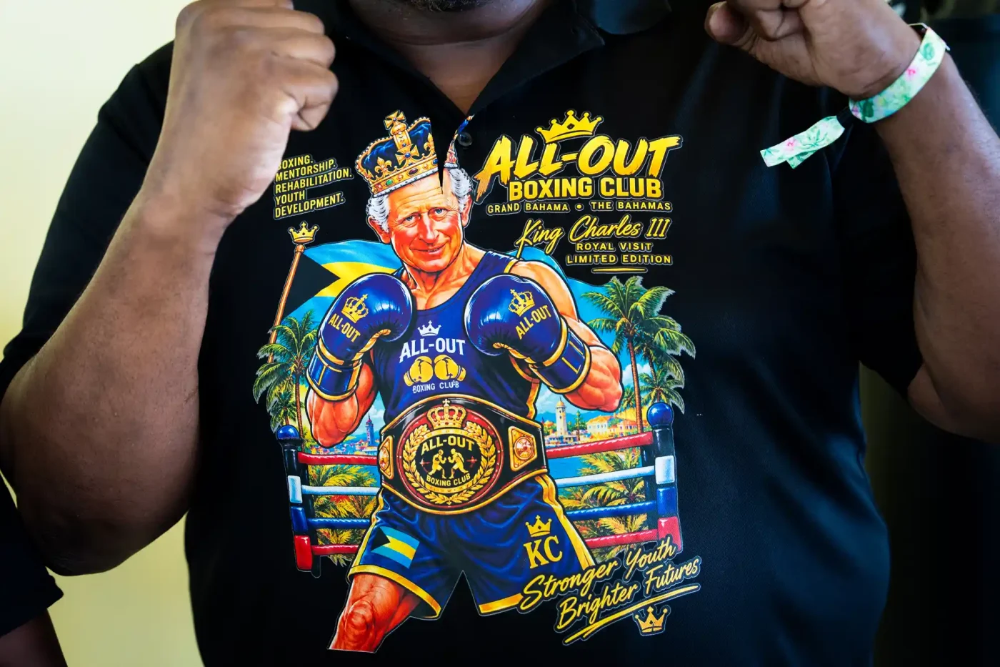 A member of staff wears a t-shirt featuring an illustration depicting King Charles III as a boxer, ahead of his visit to The Bahamas Boxing Academy in Nassau, as part of the royal visit to The Bahamas on October 28, 2026 in Nassau, Bahamas.