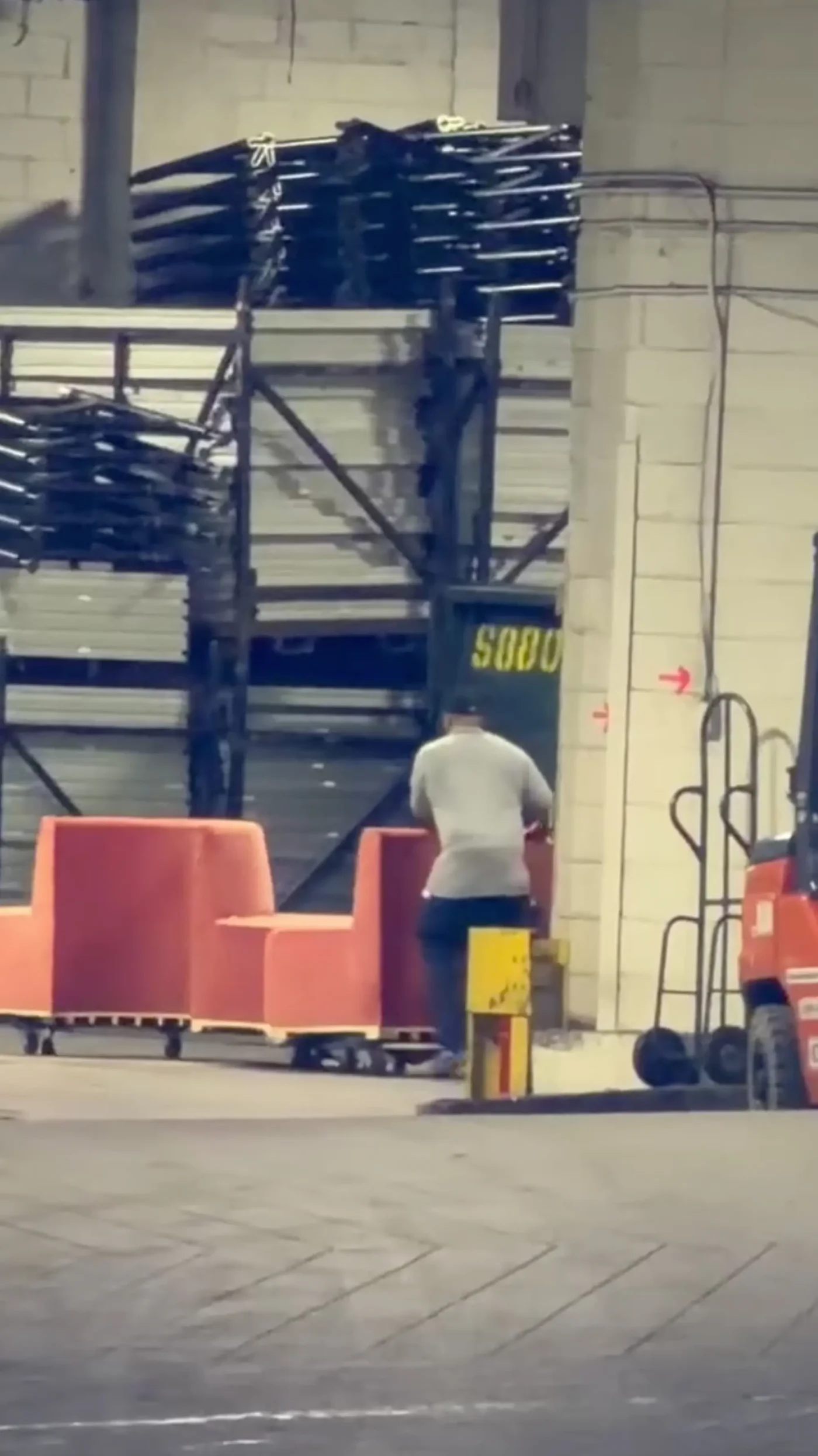 A person moves orange modular seating outside Madison Square Garden.
