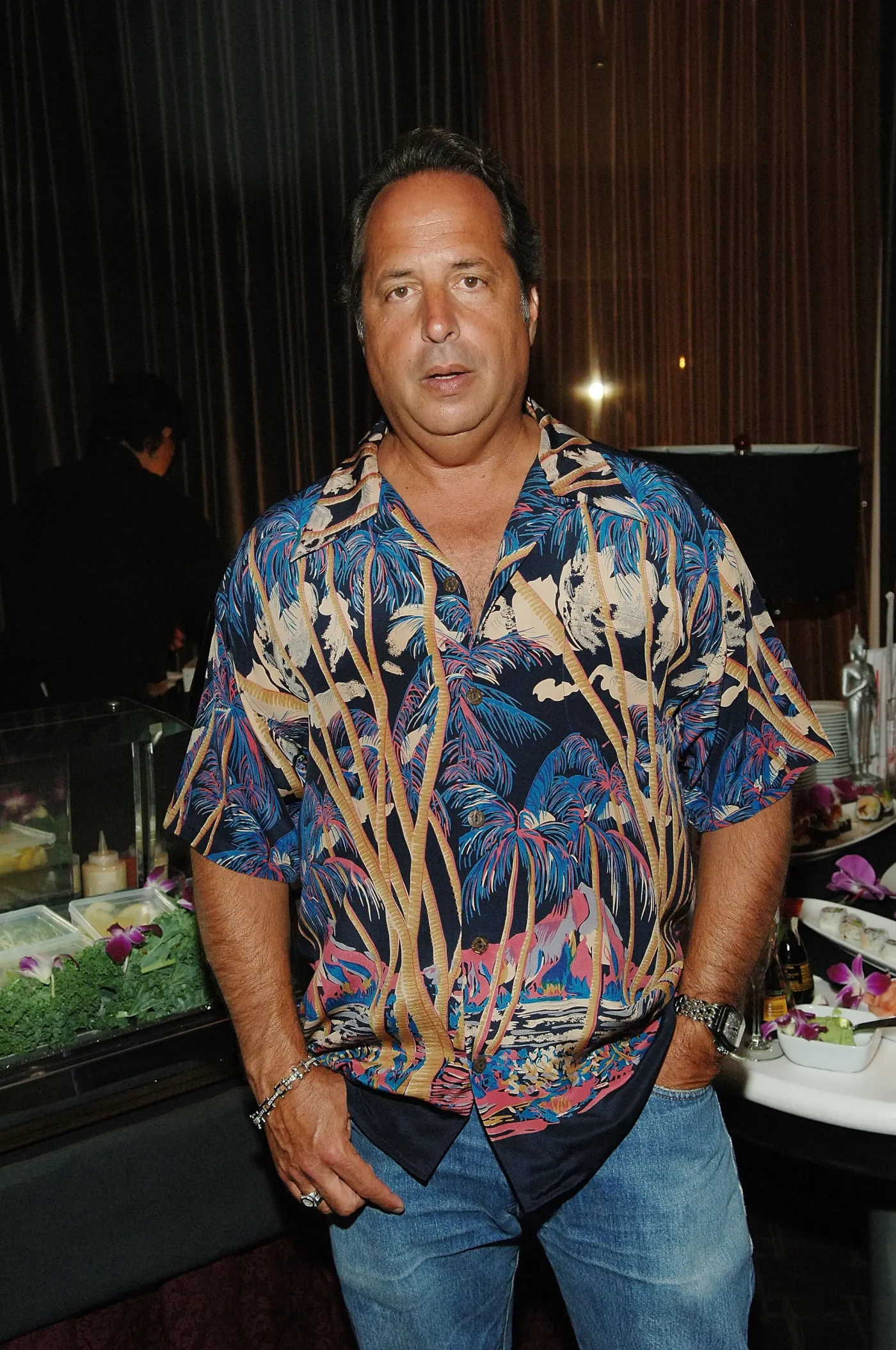 Actor Jon Lovitz in a patterned short-sleeve shirt and jeans.