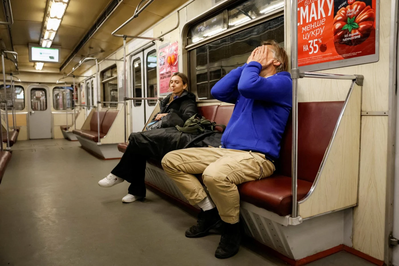 Actor Nikolaj Coster-Waldau covers his face while taking shelter inside a metro station in Kyiv.