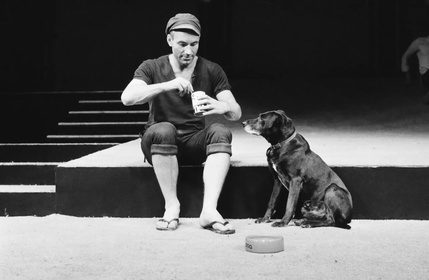 Actor Patrick Stewart as Launce, feeding his dog Crab during a rehearsal for