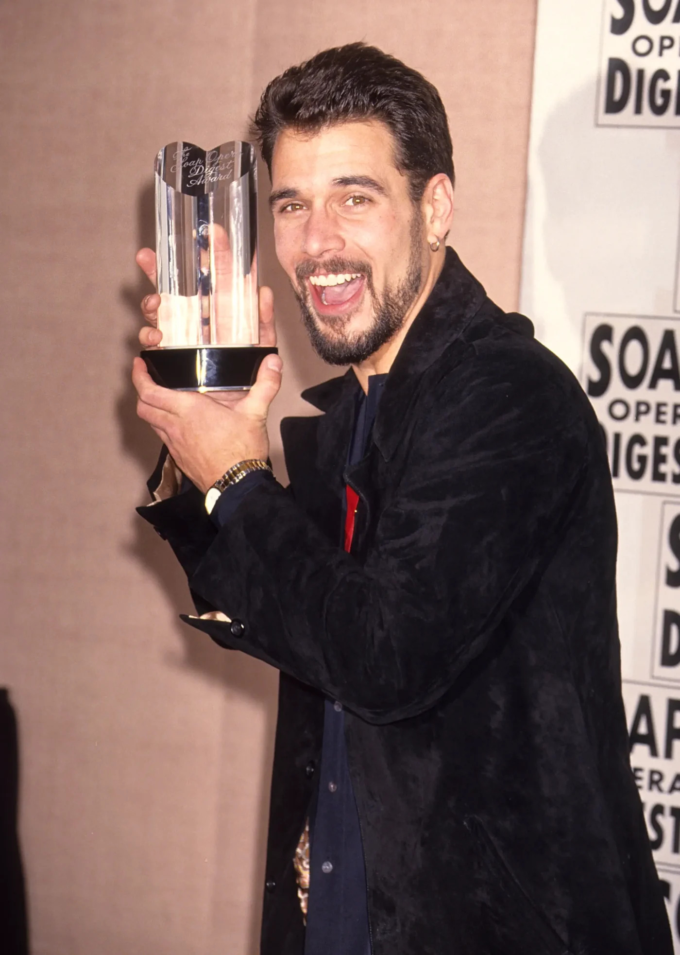 Actor Robert Kelker Kelly holds a Soap Opera Digest Award.