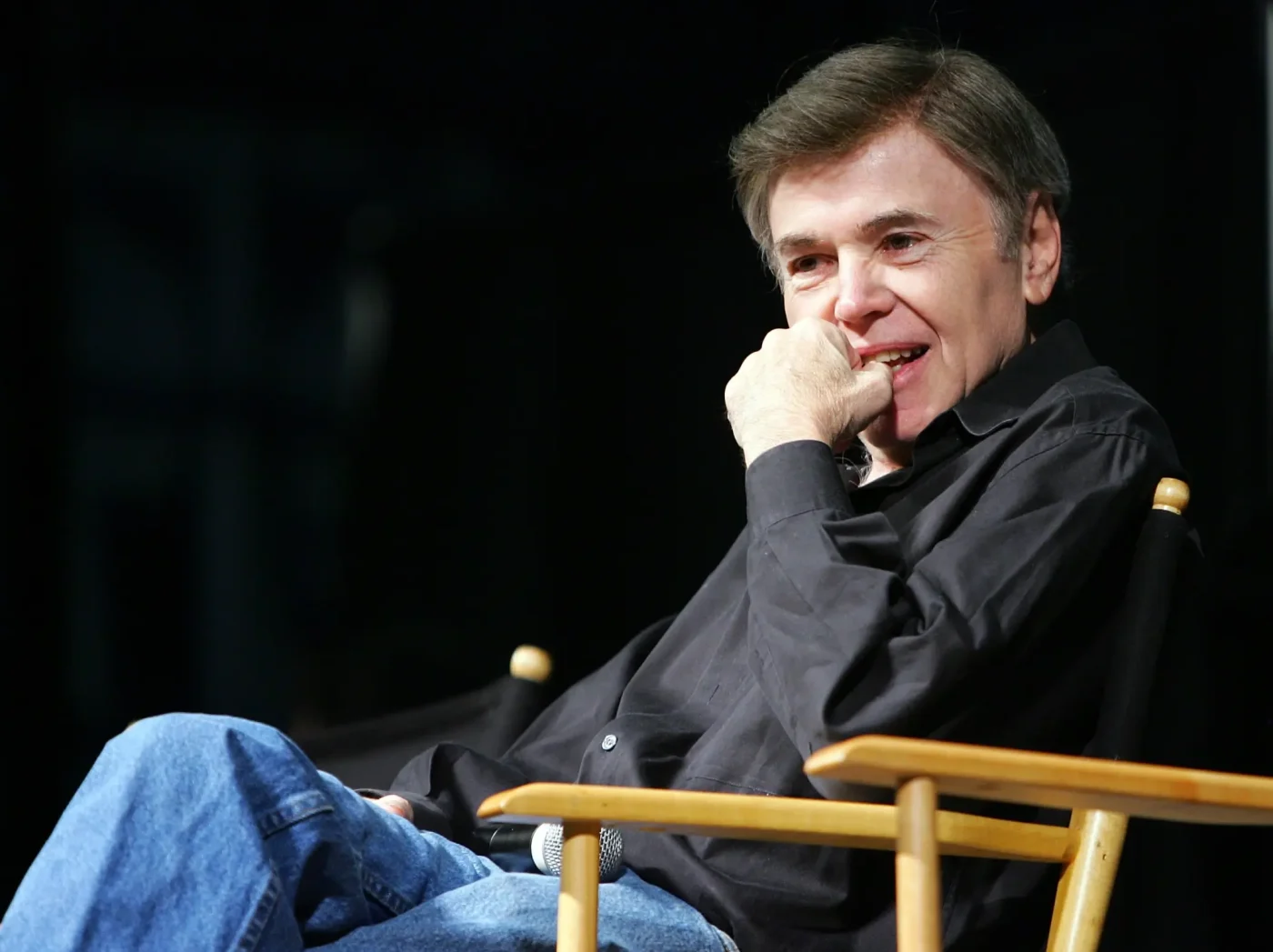 Actor Walter Koenig smiling while sitting in a director