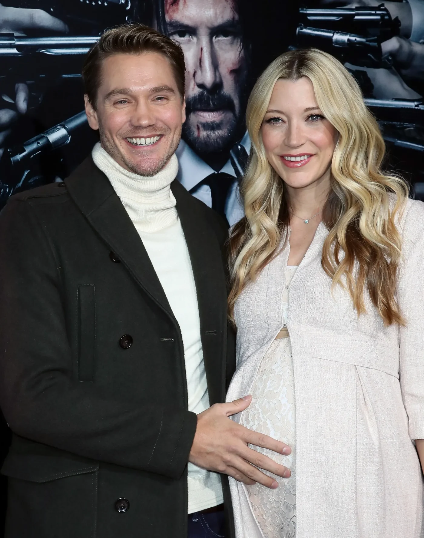 Actors Chad Michael Murray and Sarah Roemer smiling together on a red carpet, with Murray