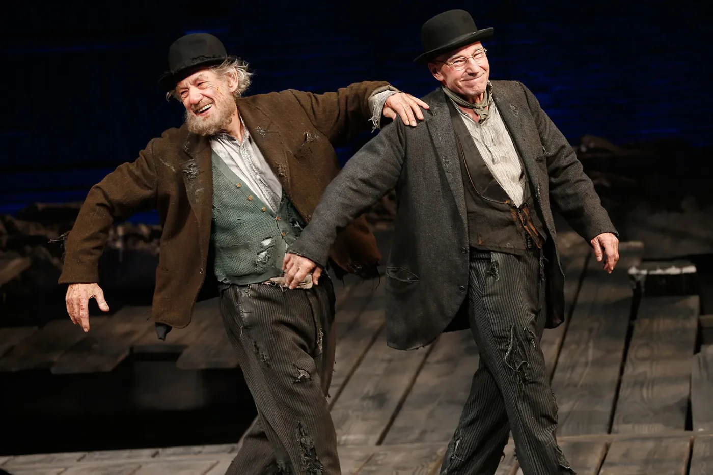 Actors Ian McKellen and Patrick Stewart perform a dance during curtain call at the opening night of