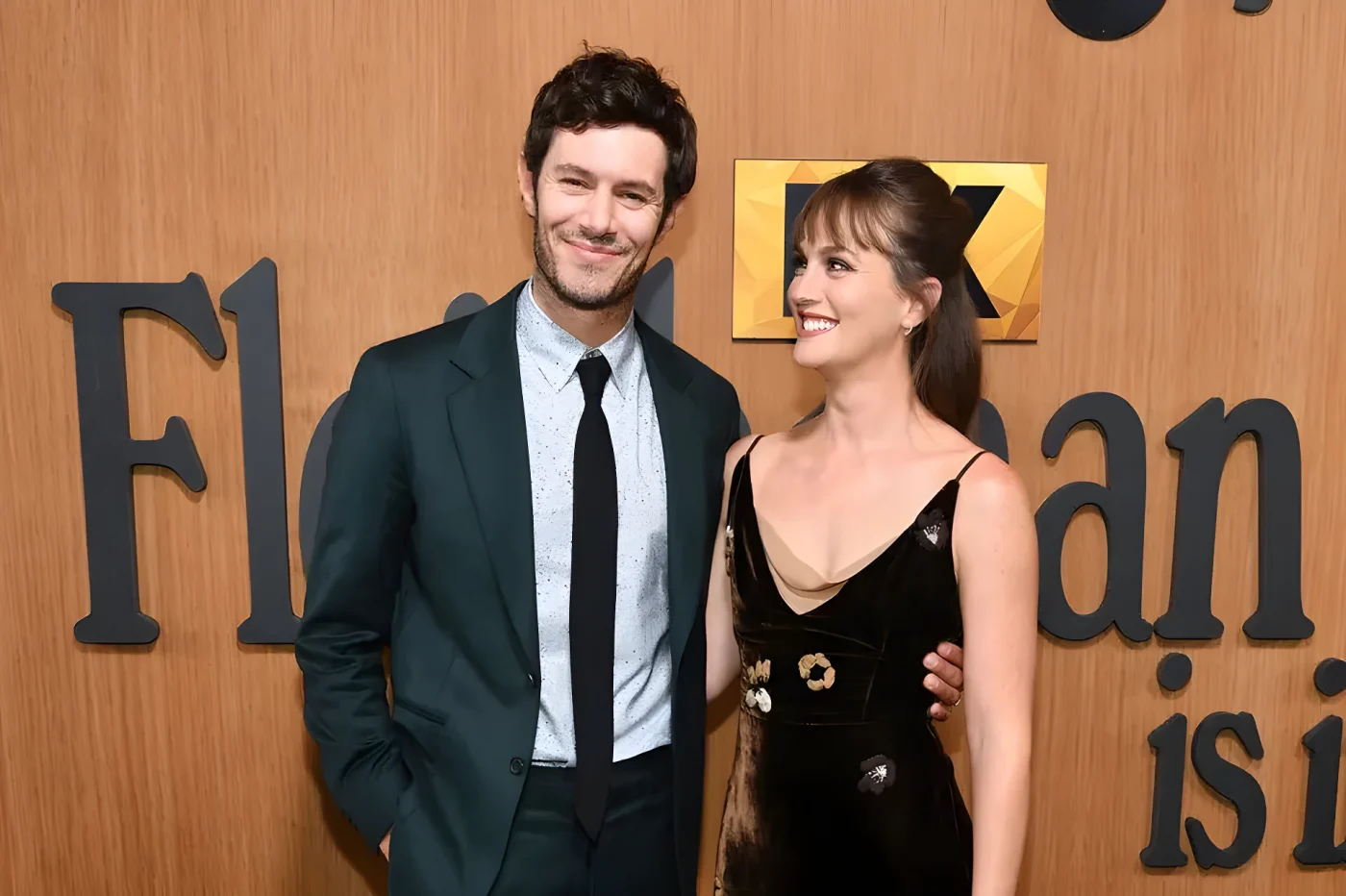 Adam Brody and Leighton Meester smiling at eachother