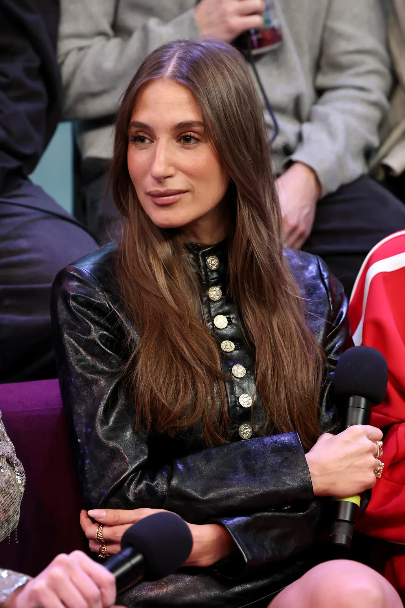 Amanda Batula seated and holding a microphone during an appearance at SiriusXM Studios.