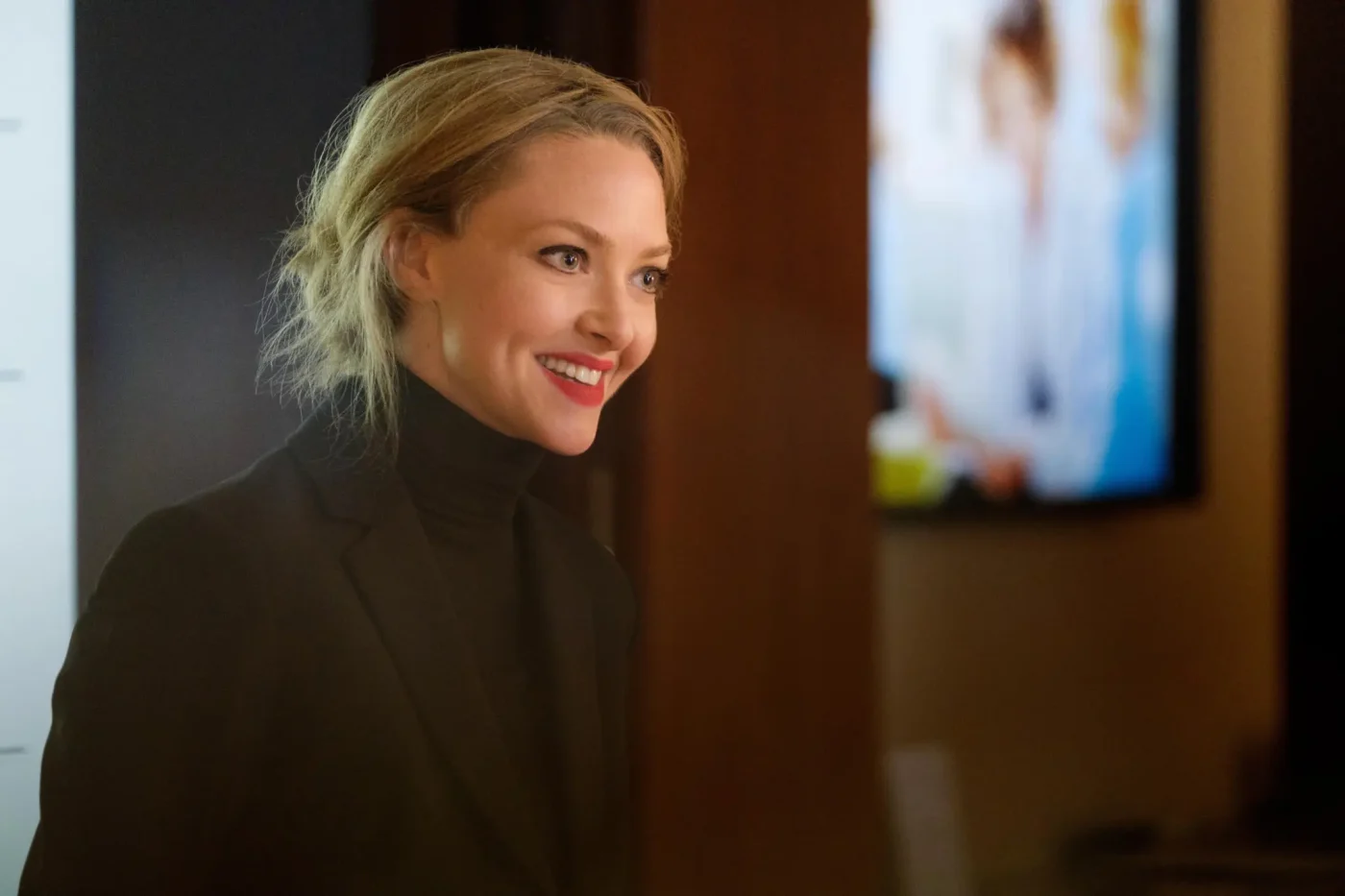 Amanda Seyfried as Elizabeth Holmes wearing a black turtleneck in a scene from The Dropout.