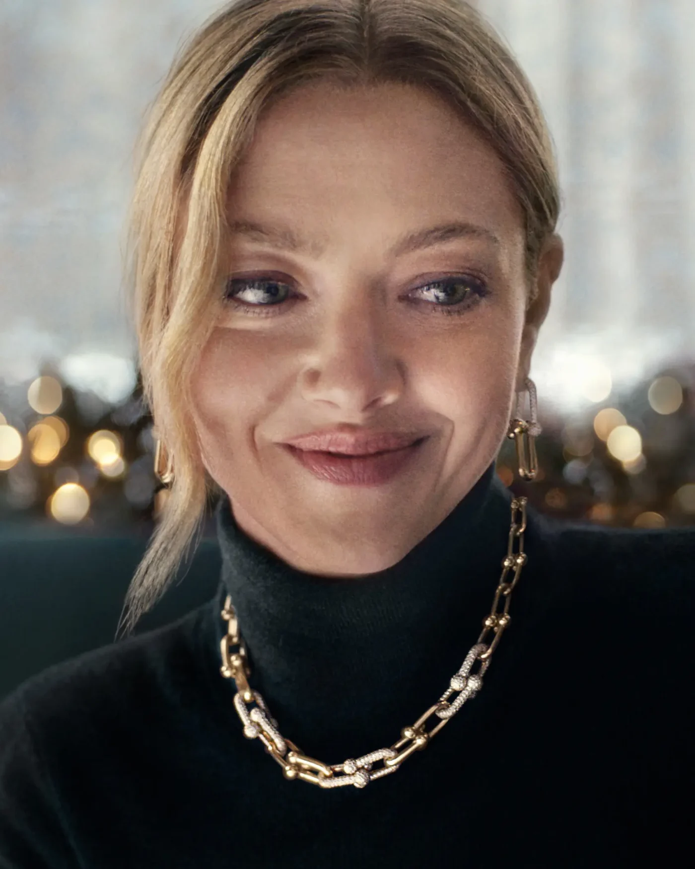Amanda Seyfried wearing gold and diamond jewelry in a Tiffany & Co. campaign.