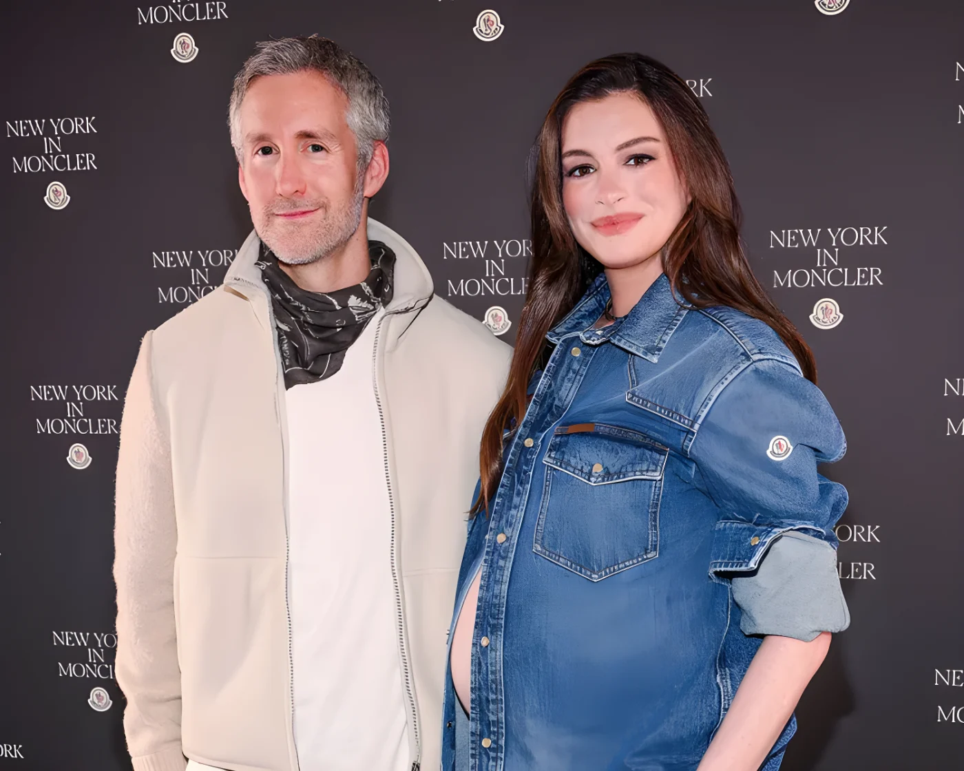 Anne Hathaway and a man posing together at an event