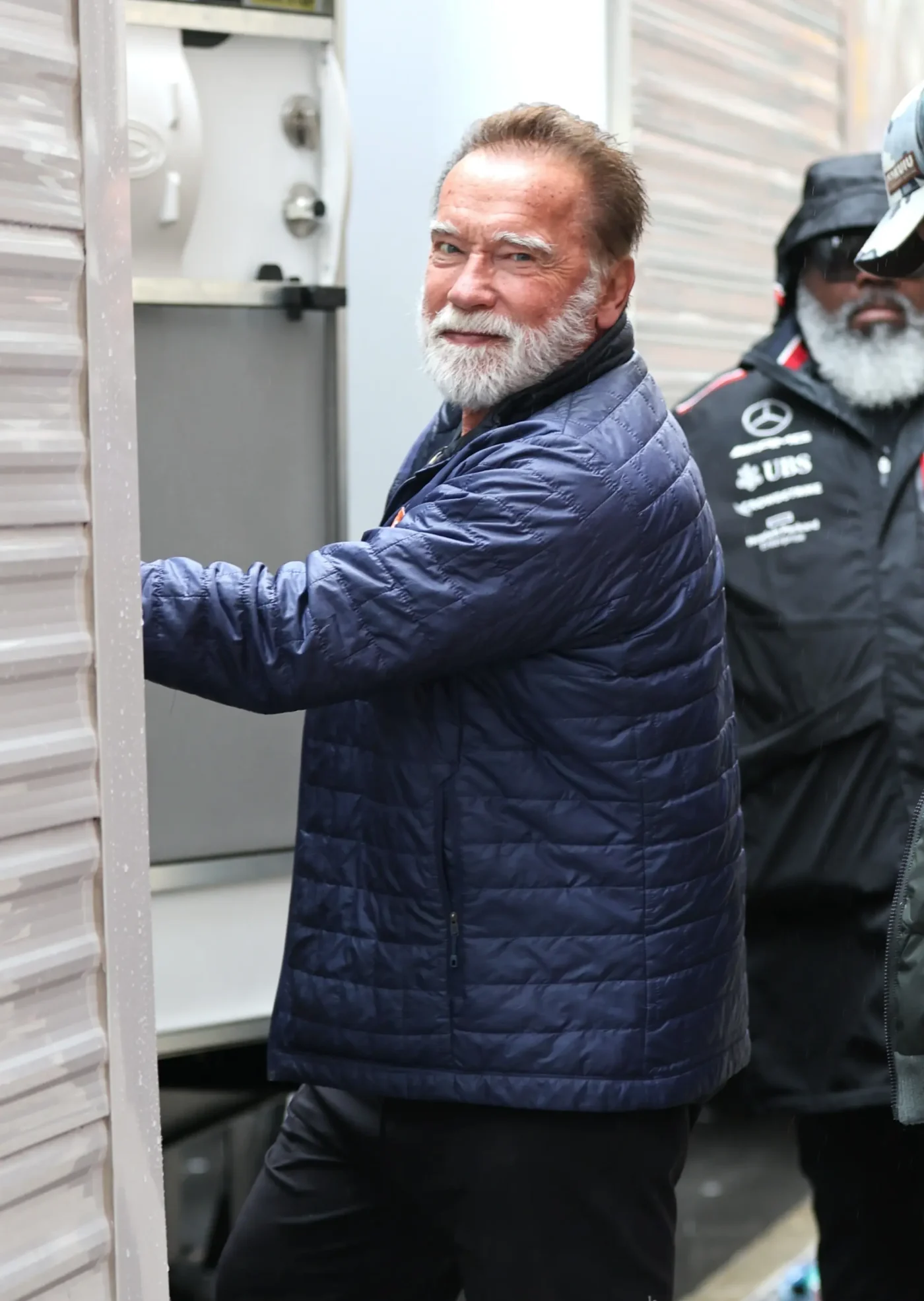 Arnold Schwarzenegger with a white beard is seen on the set of the film