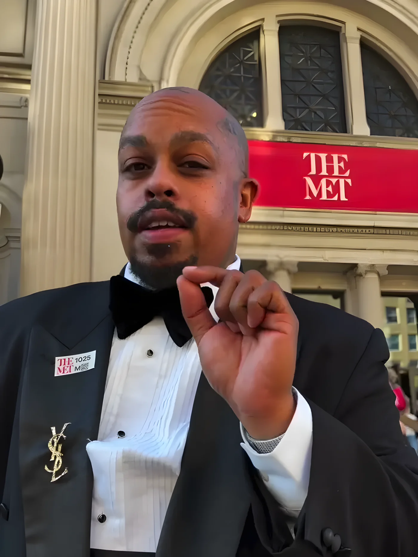 Artist David Sabastian in a tuxedo in front of The Met.