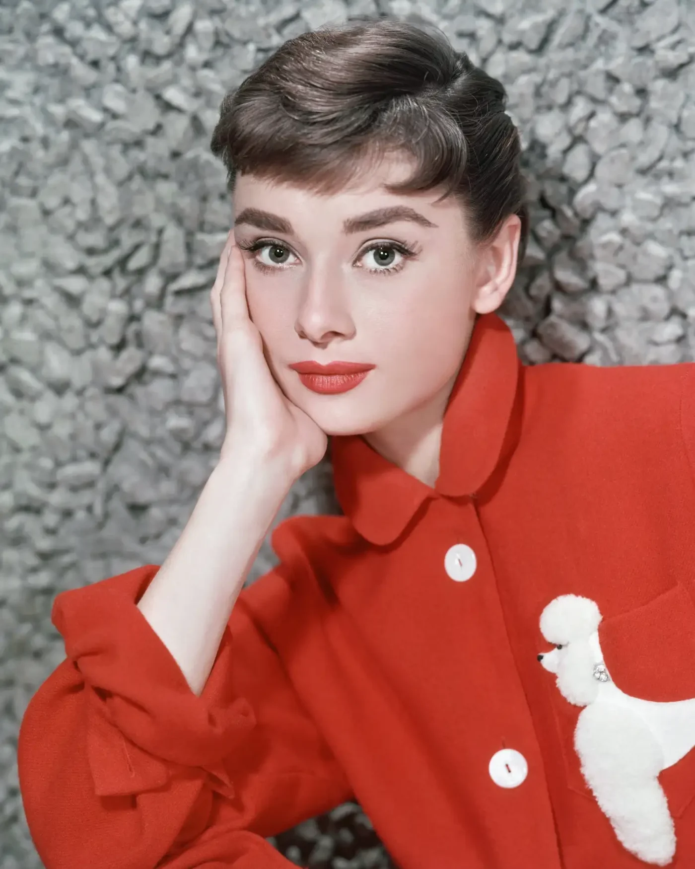 Audrey Hepburn posing with her hand resting on her cheek