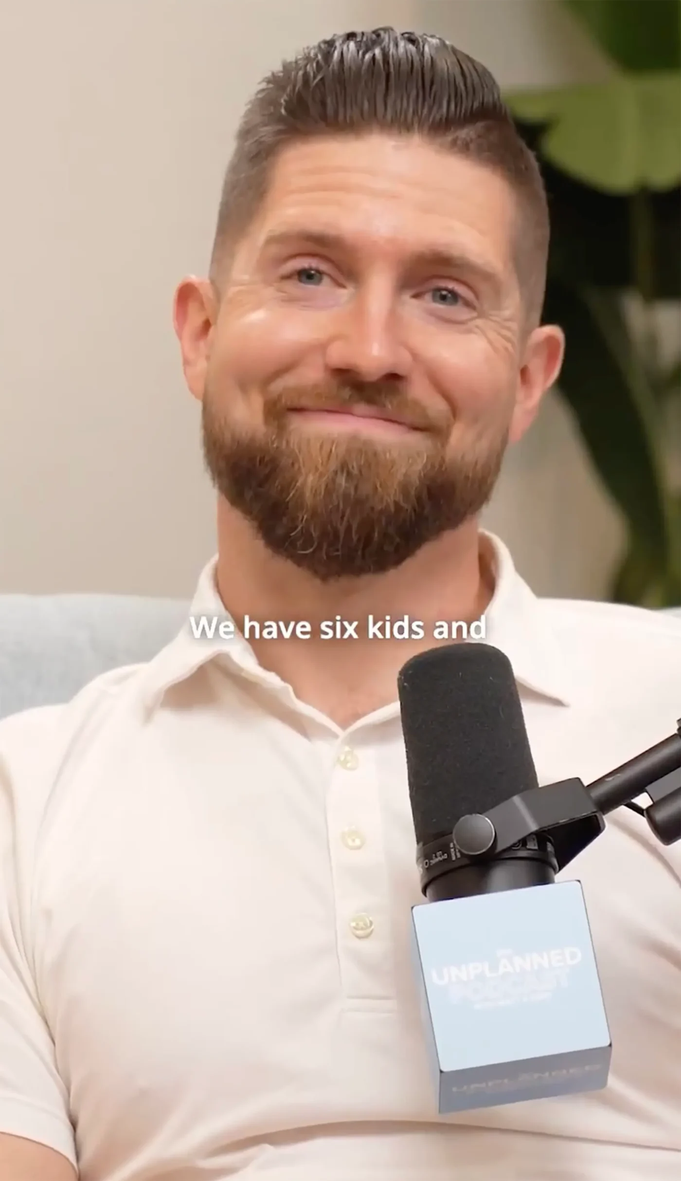 Ben Seewald smiling while speaking on The Unplanned Podcast with a microphone in front of him.