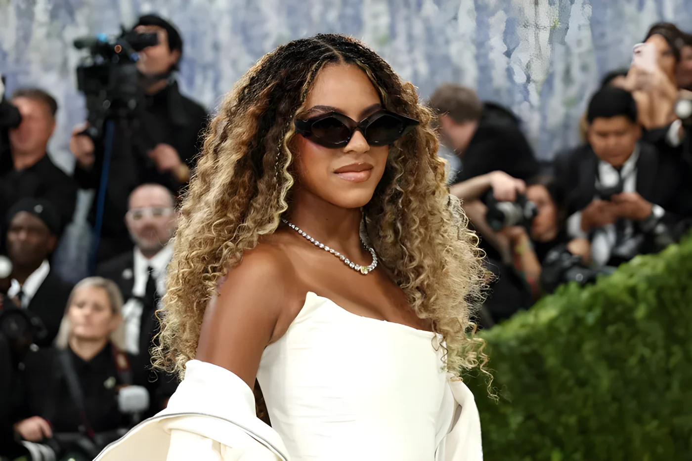Beyonc at a formal event wearing sunglasses and a white outfit