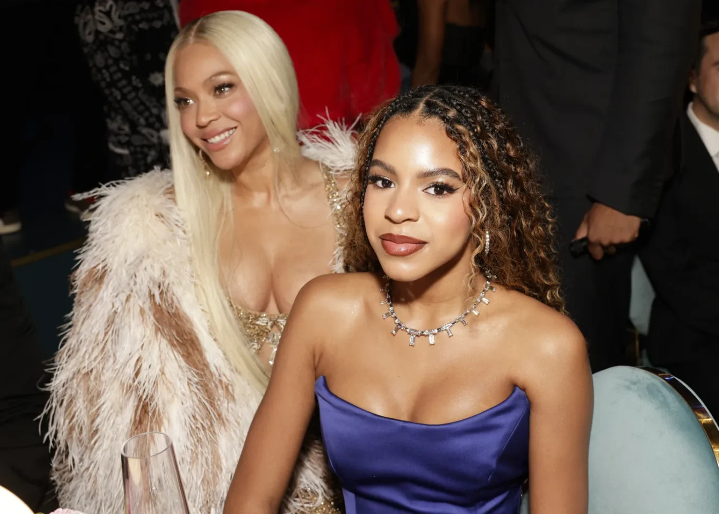 Beyonc seated with another individual at an event both facing forward