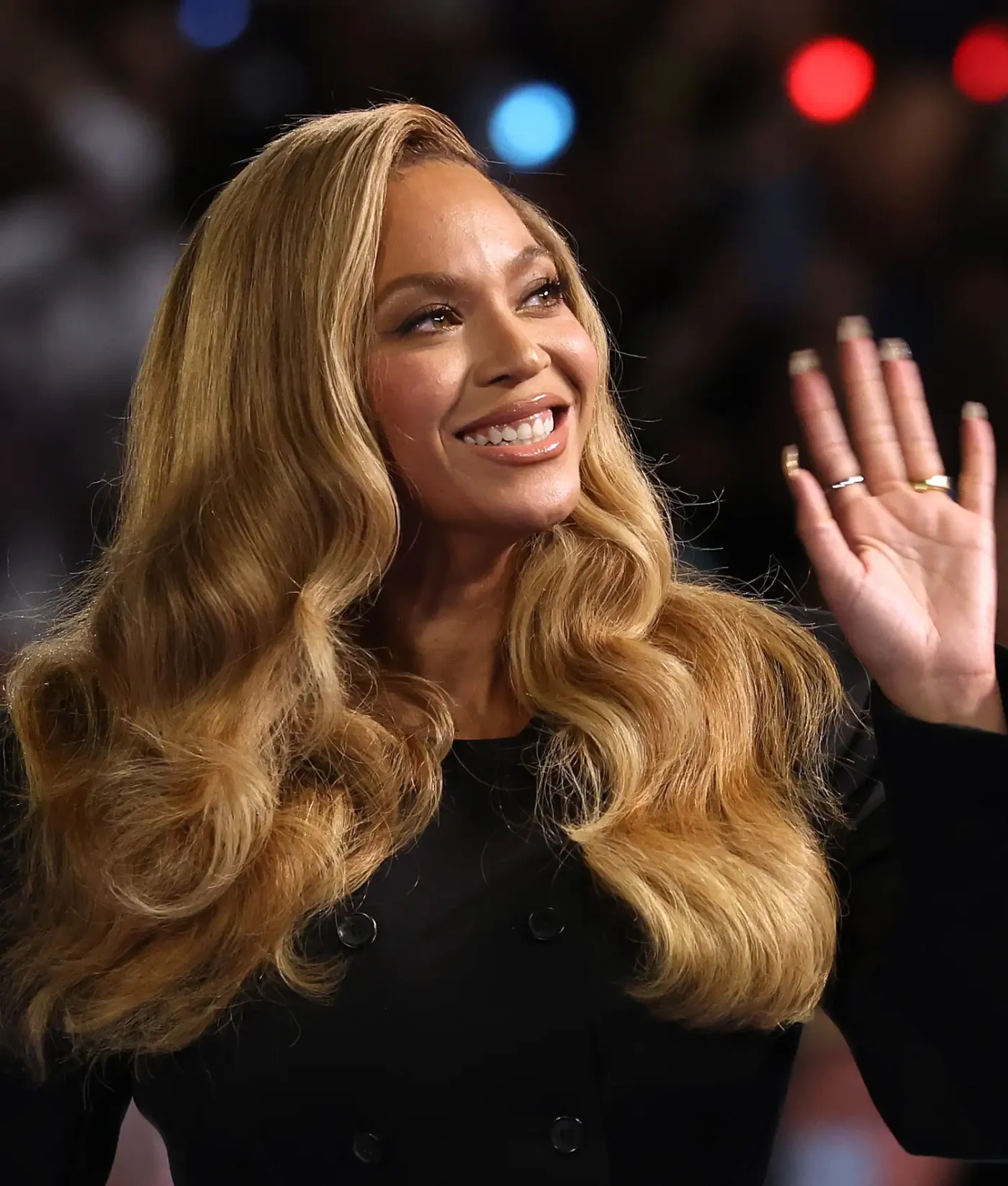 Beyonc smiling and waving at an event