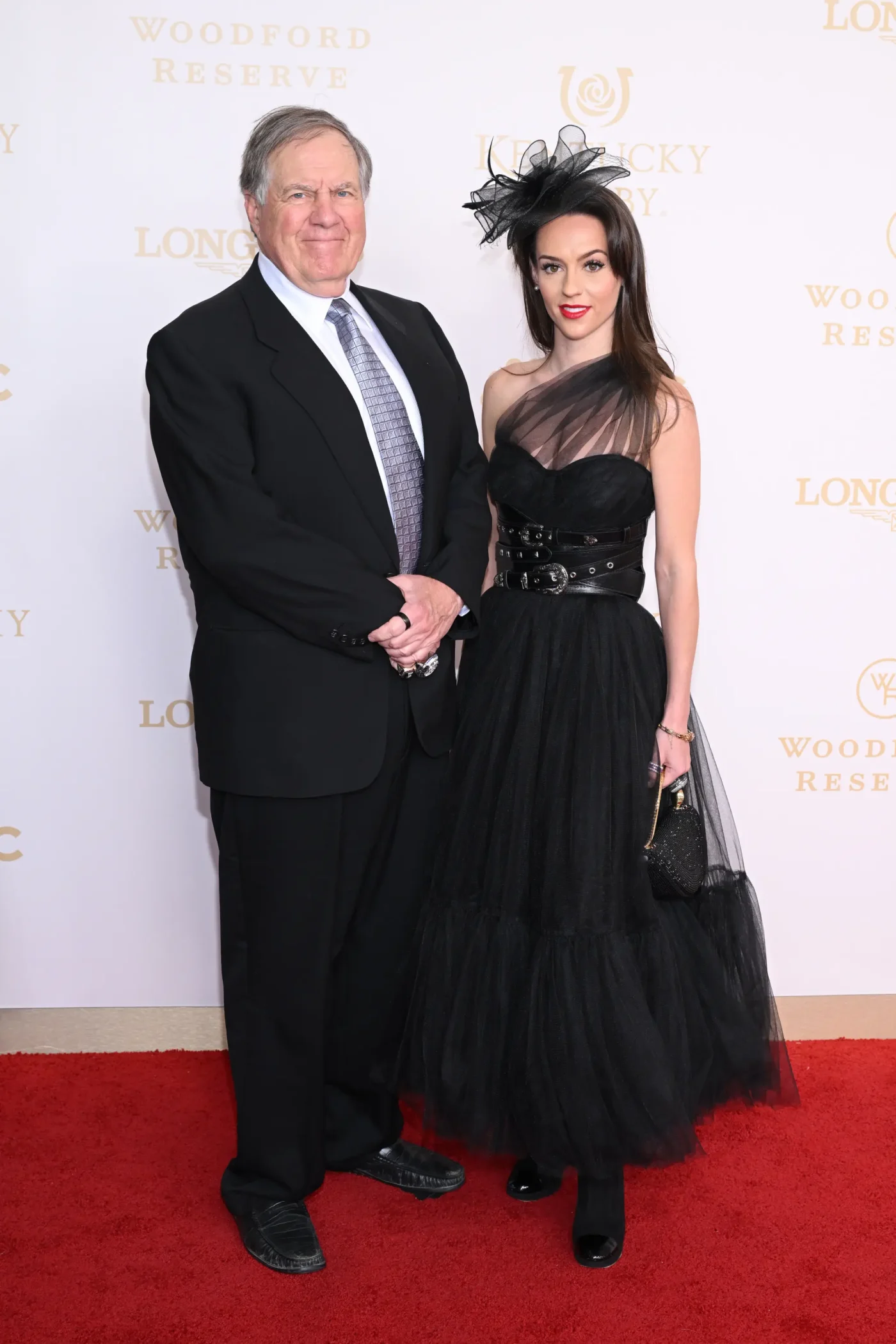 Bill Belichick and Jordon Hudson attend an event on a red carpet.