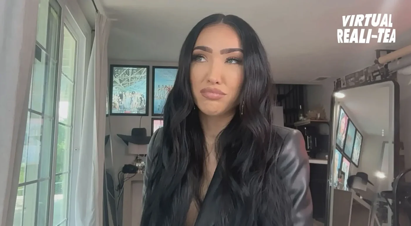 Bre Tiesi looking to the side with an uncertain expression.