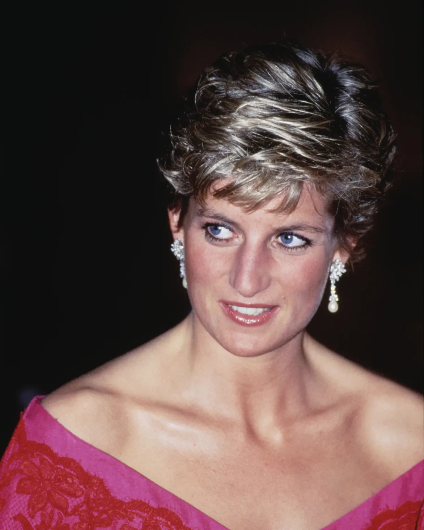 British Royal Diana, Princess of Wales (1961-1997), wearing a pink-and-red Catherine Walker suit, attends an unspecified event at the Barbican Centre in London, England, 29th November 1990. (