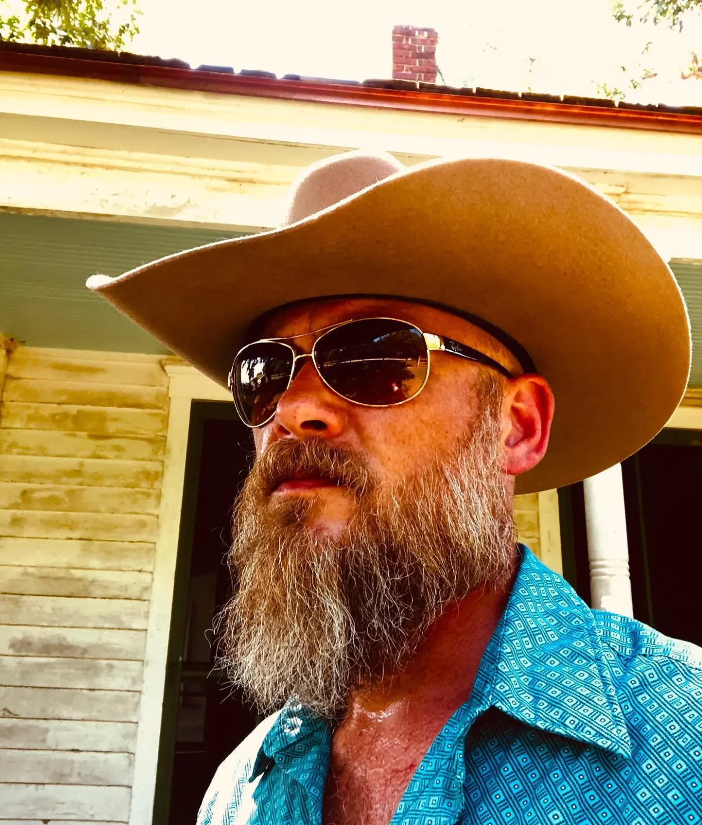 Bryan Seaver wearing a cowboy hat and sunglasses outdoors.