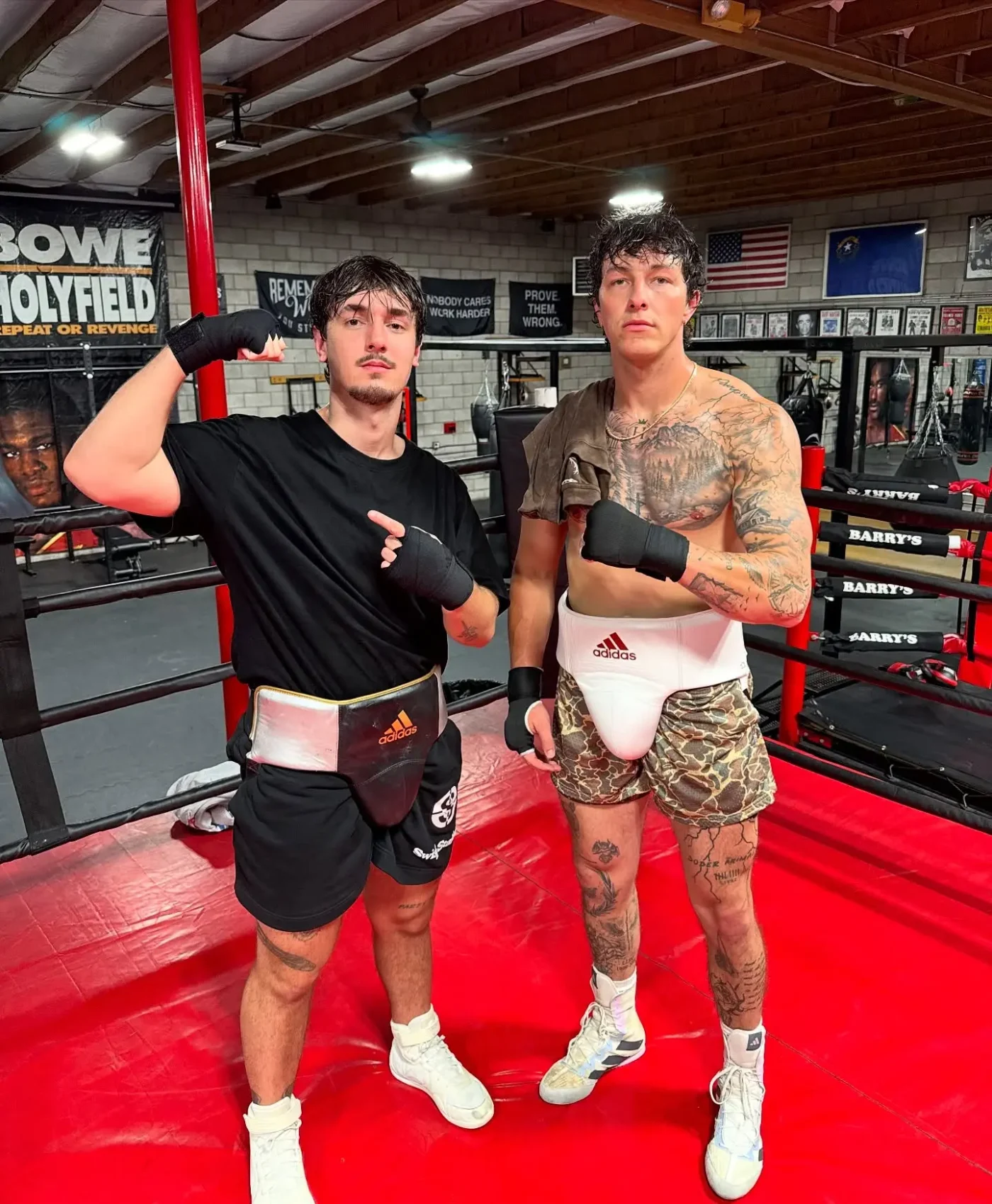Bryce Hall and another man posing inside a boxing ring.