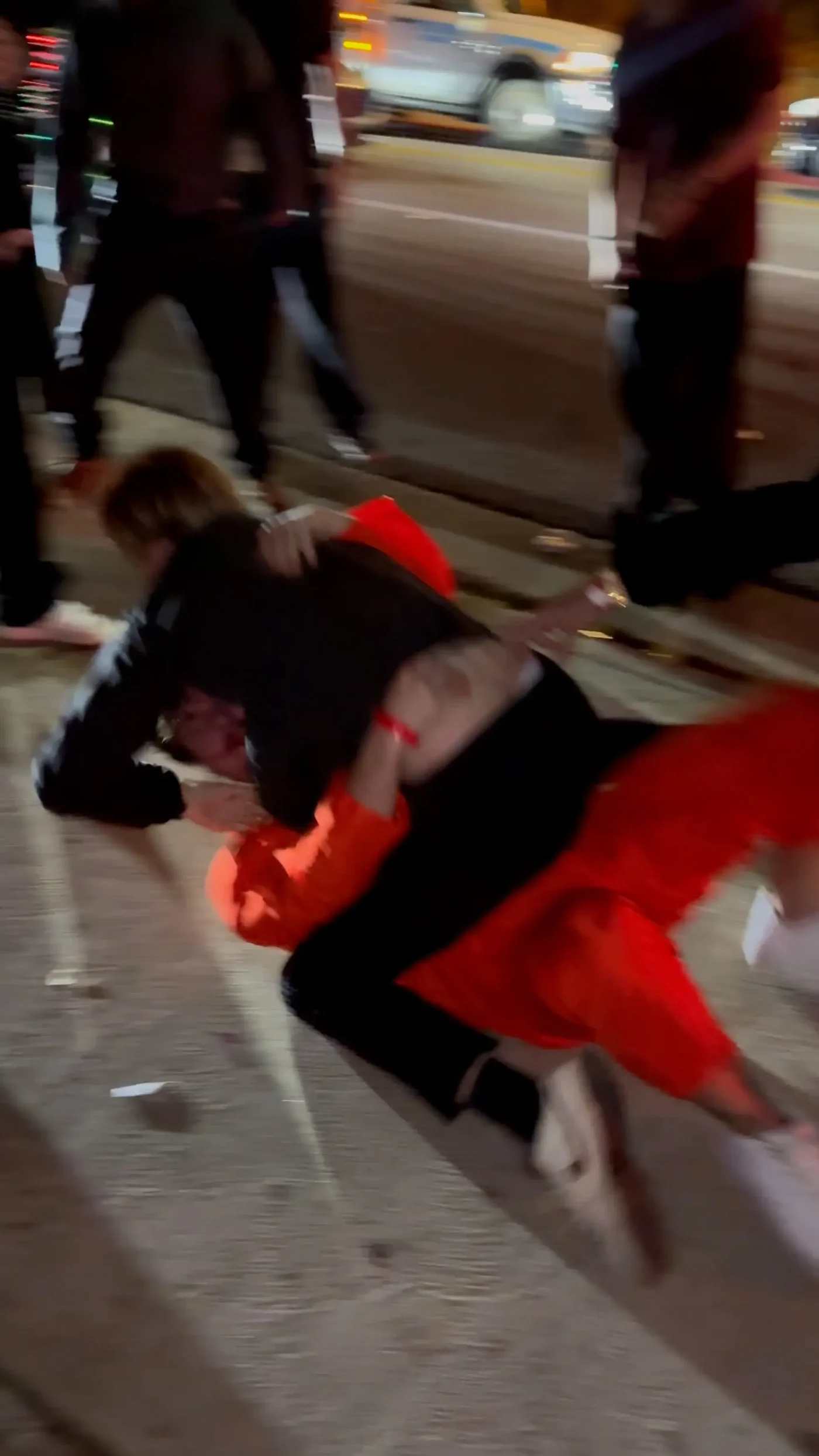 Bryce Hall, wearing an orange jumpsuit, involved in a physical altercation with multiple men outside a Halloween party.