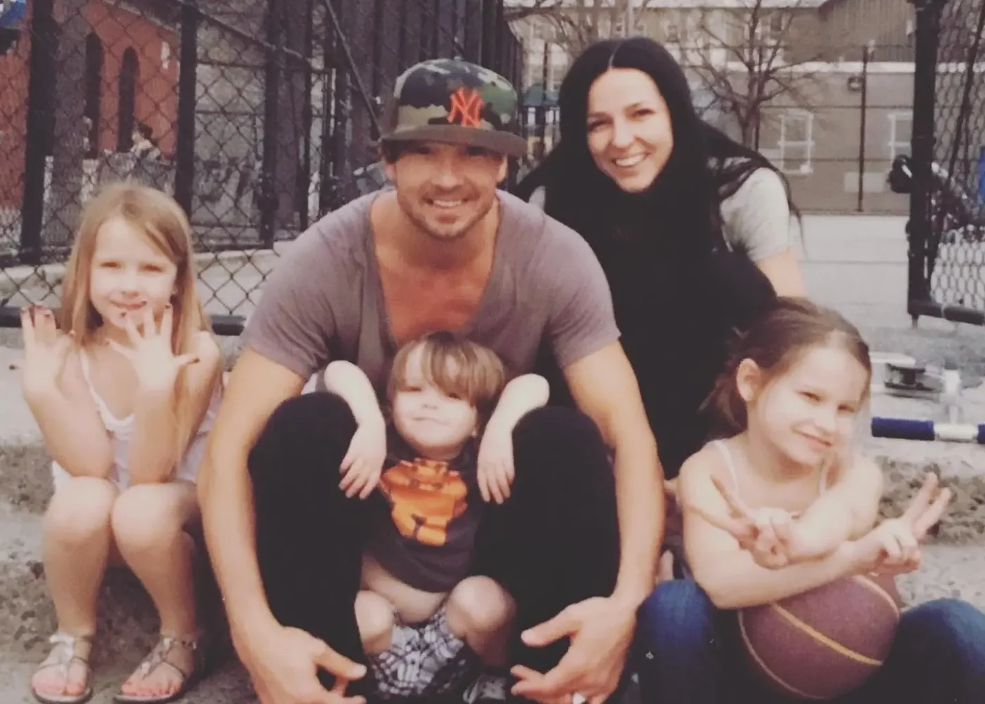 Carl Lentz and his family posing together outdoors.