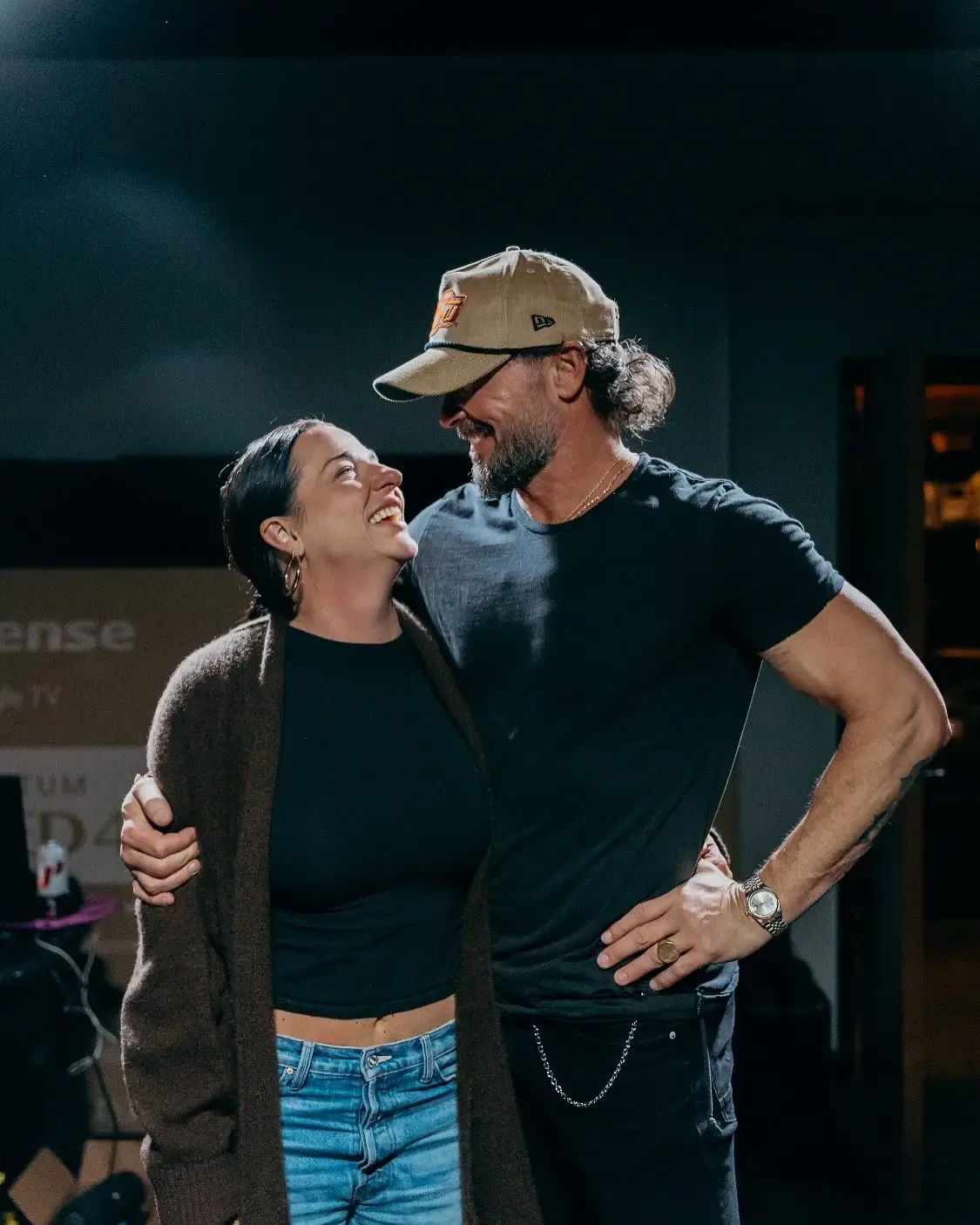 Carl Lentz and his wife Laura standing together and smiling at each other.