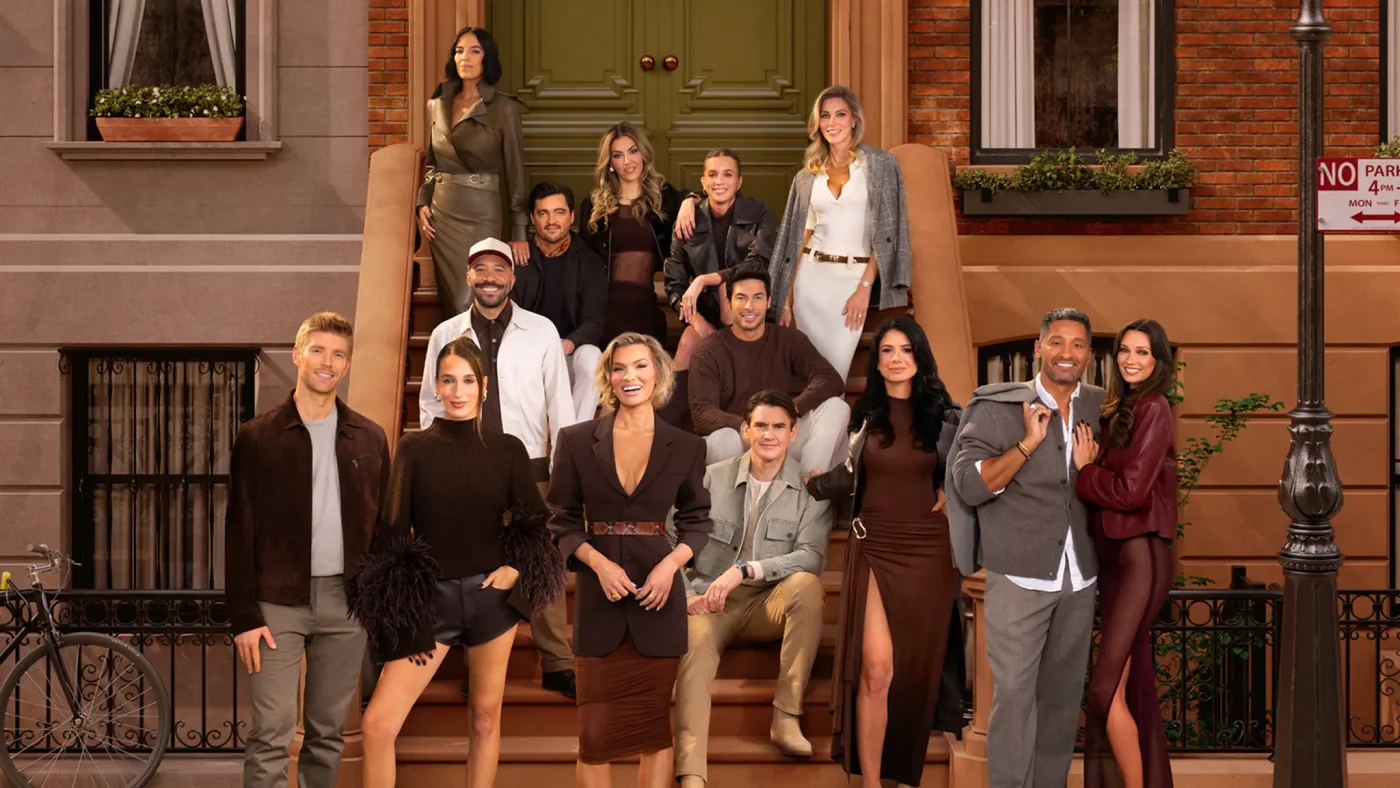 Cast members of Winter House pose together outside a brownstone building.