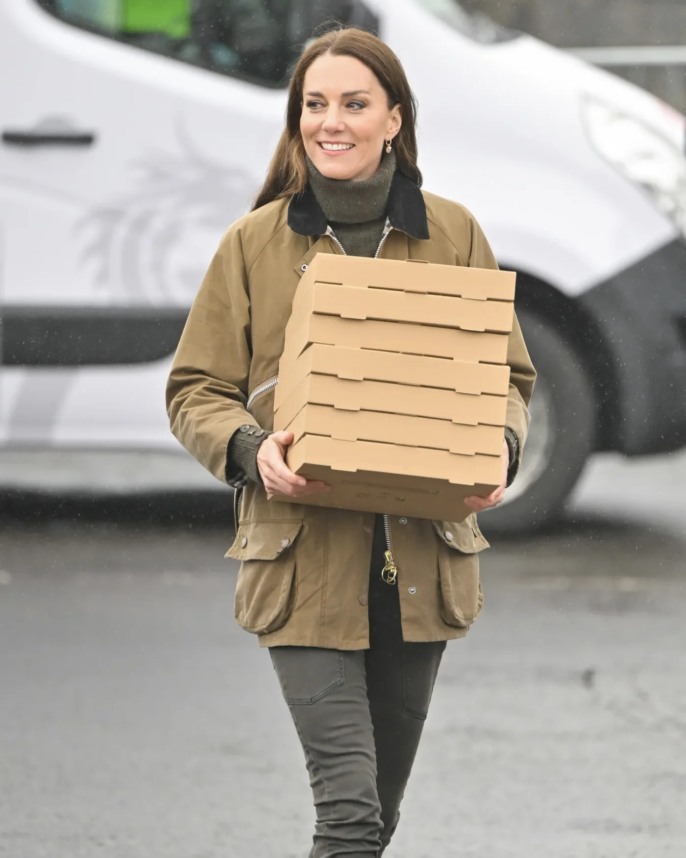 Catherine, Princess of Wales smiles carrying pizza boxes at Dowlais Rugby Club during a 2 day visit to Wales on April 27, 2023 in Merthyr Tydfil, Wales.