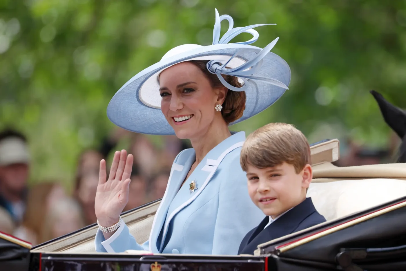 Catherine, Princess of Wales, waving in a carriage alongside Prince Louis of Wales during Trooping the Colour.